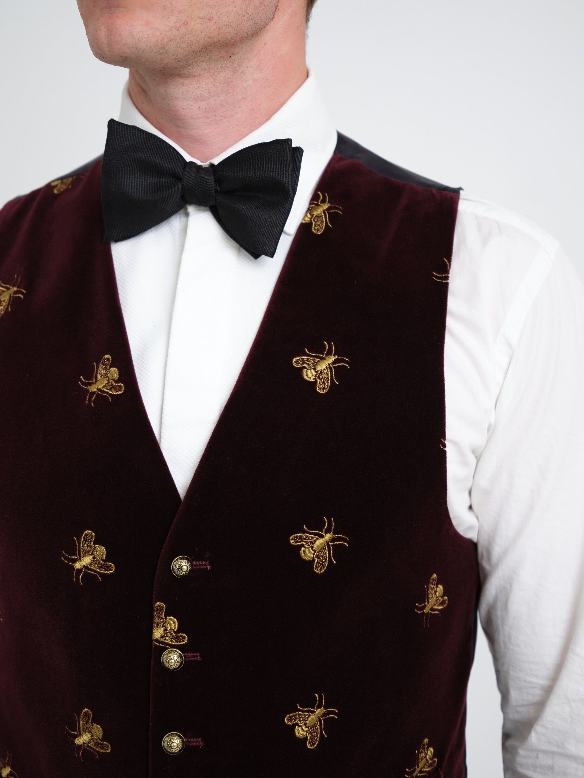 Burgundy velvet waistcoat — gold bee embroidery and engraved gilt buttons