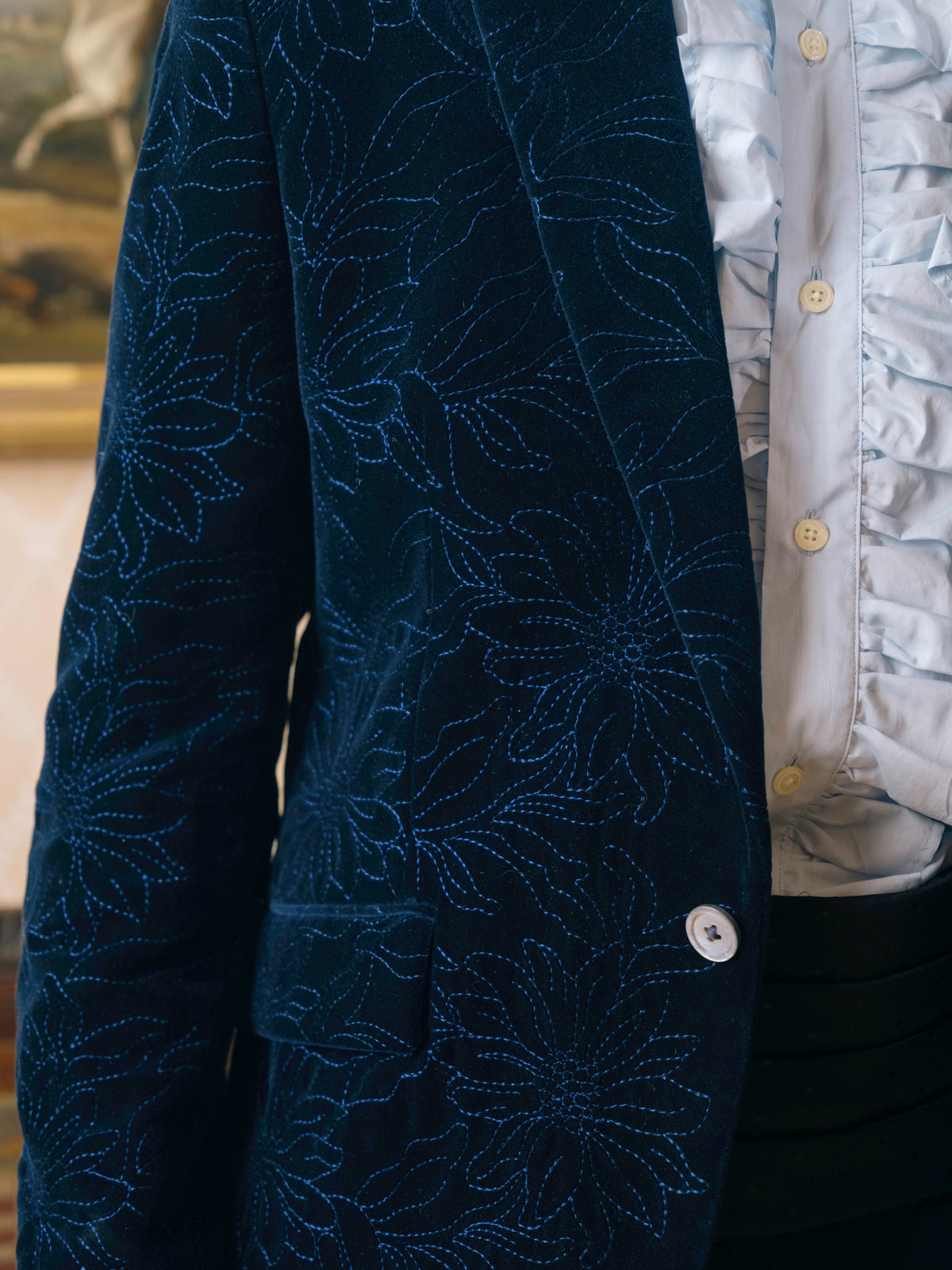 Close detail of the embroidery on a navy velvet dinner jacket