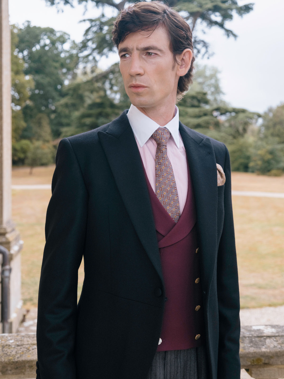 A black morning coat and burgundy waistcoat, three quarter view